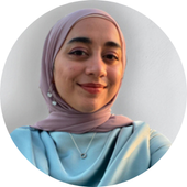woman smiles, wearing headscarf