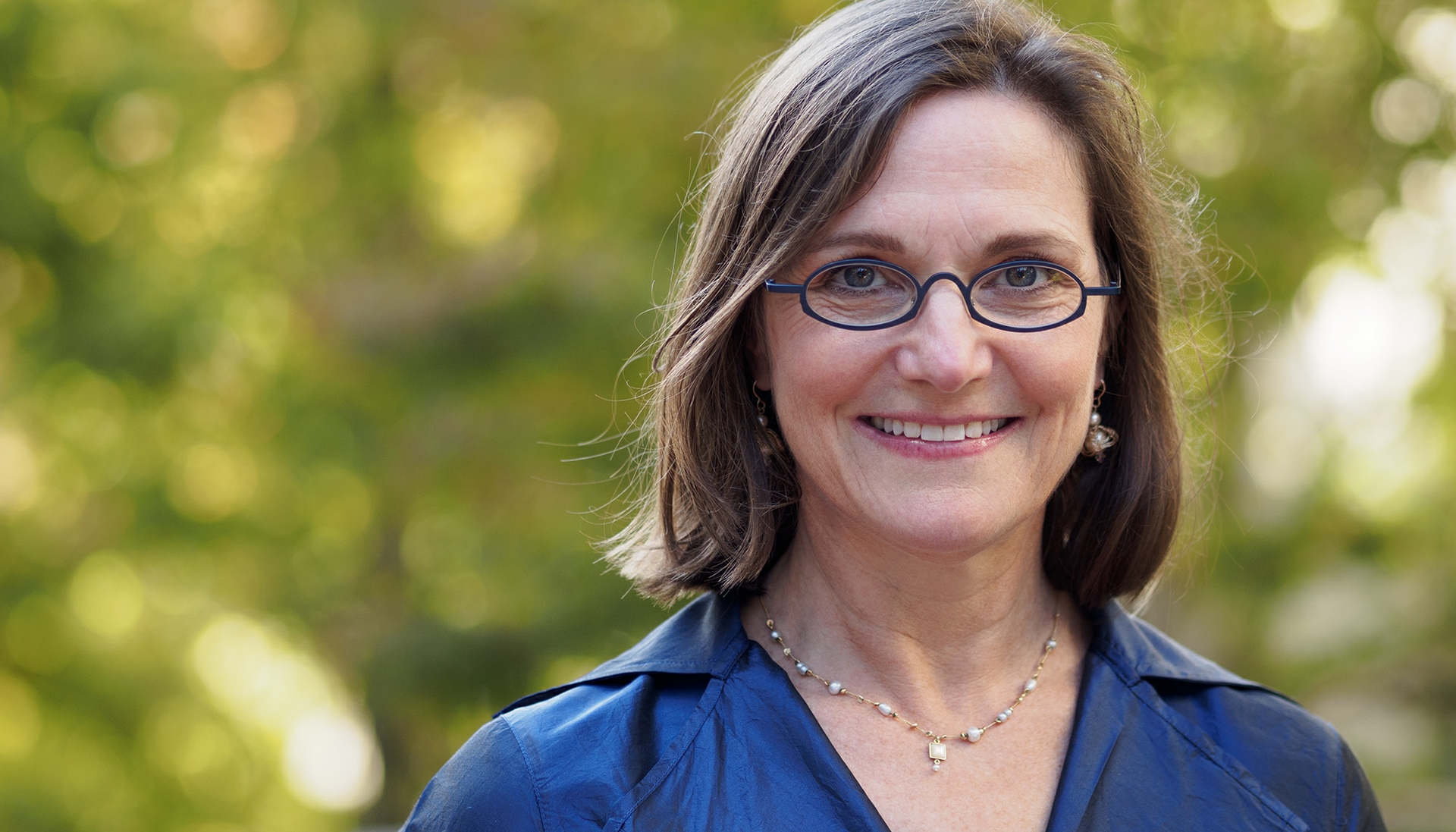 Woman wearing glasses and blue shirt