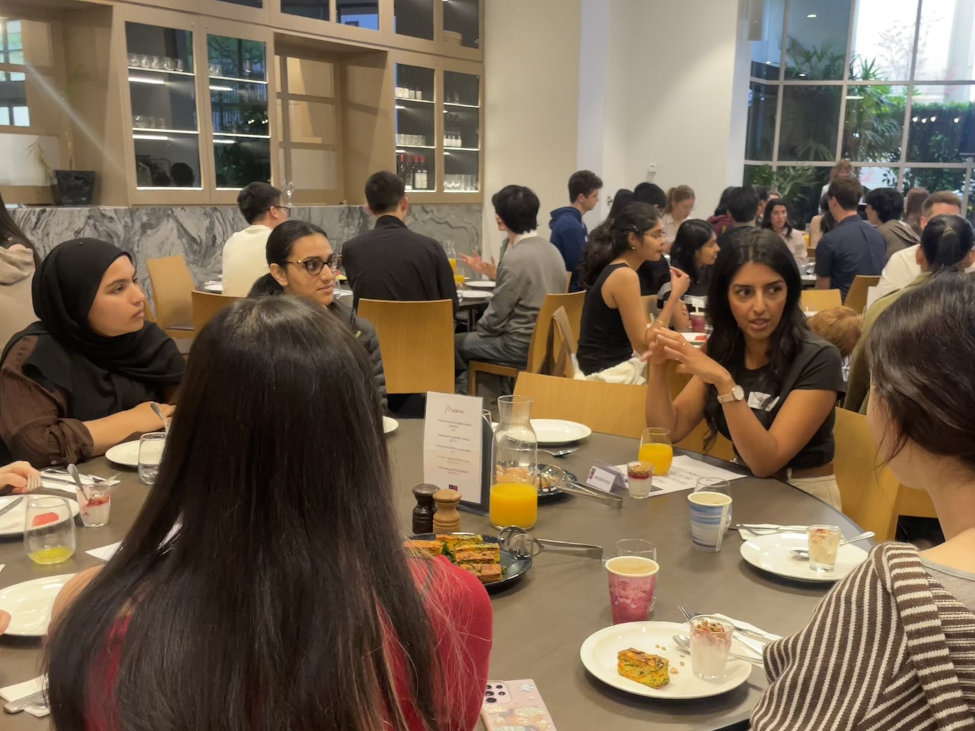people talking at breakfast table 