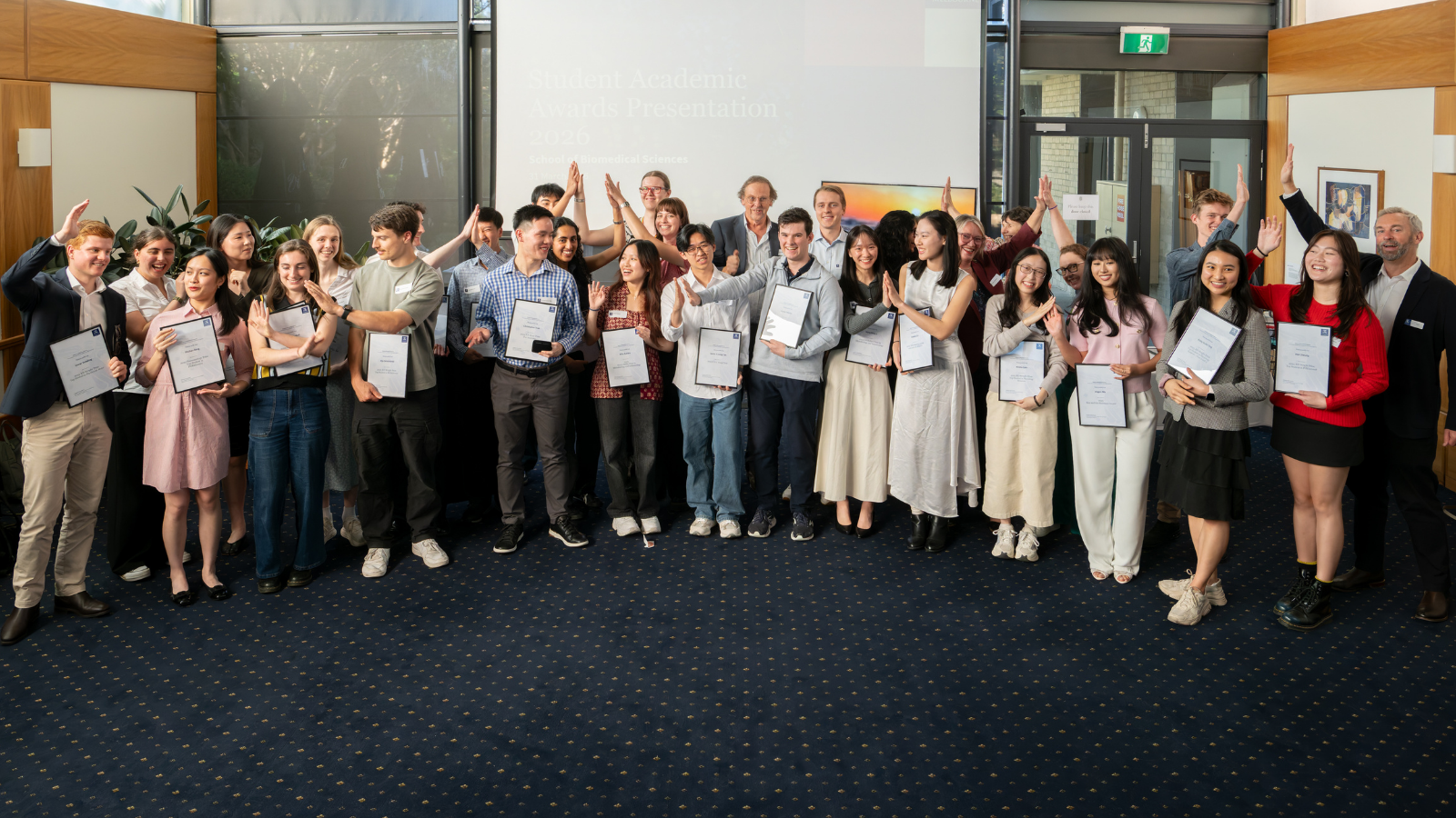 Group of uni students and teachers at celebration