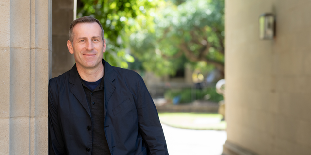 man leaning against wall outdoors