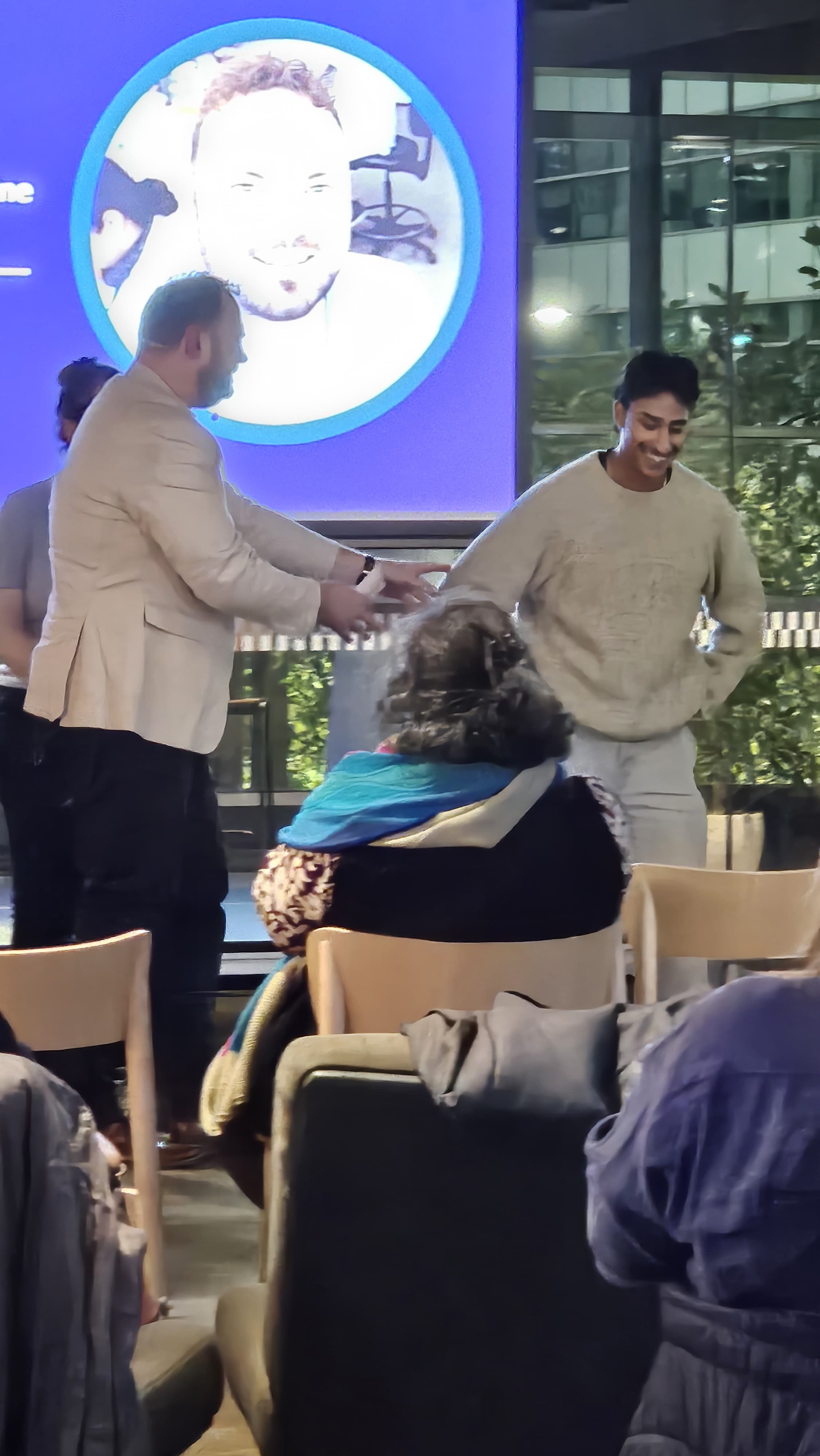 two people on stage laughing