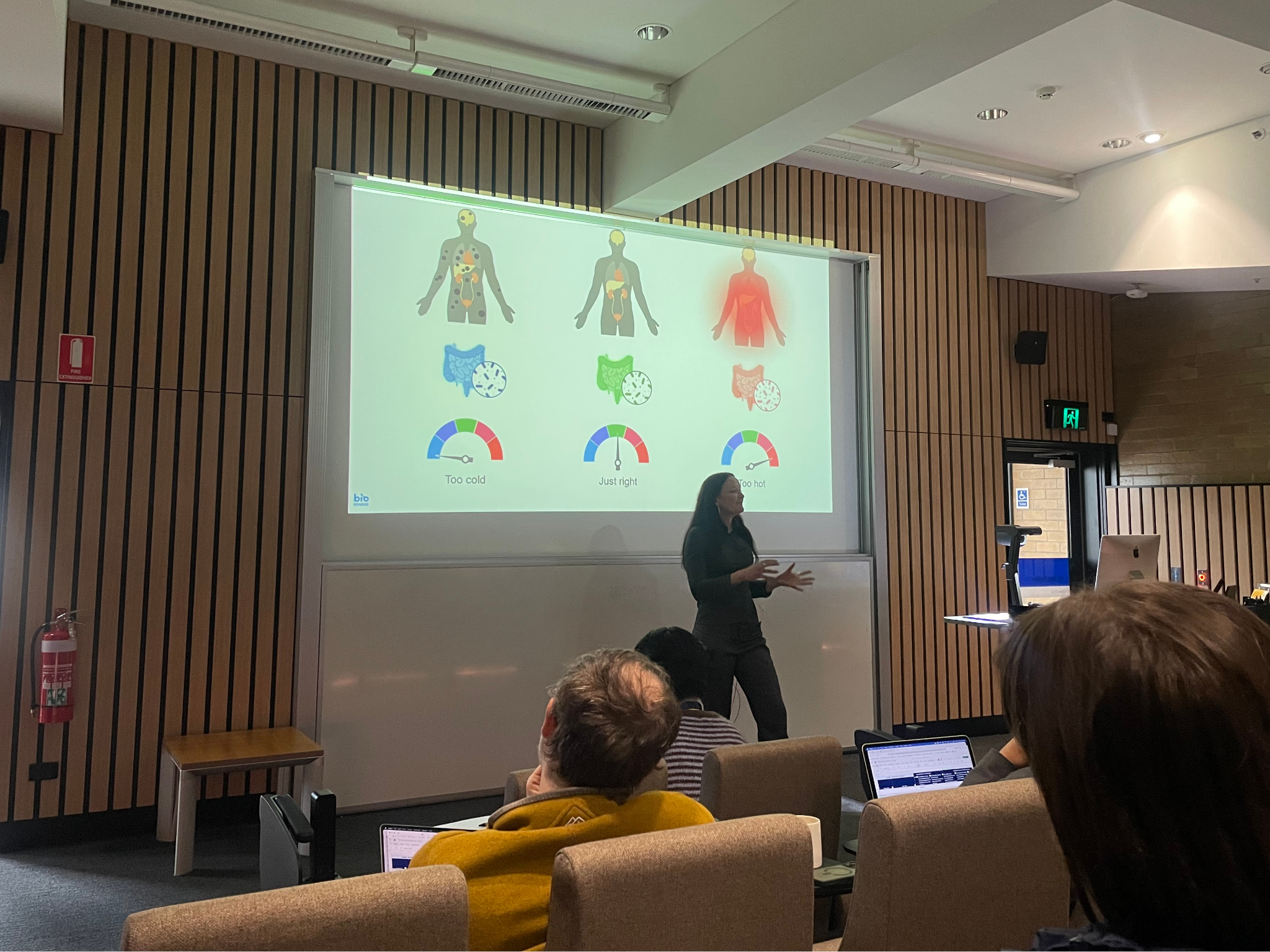 speaker in front of screen showing body diagrams