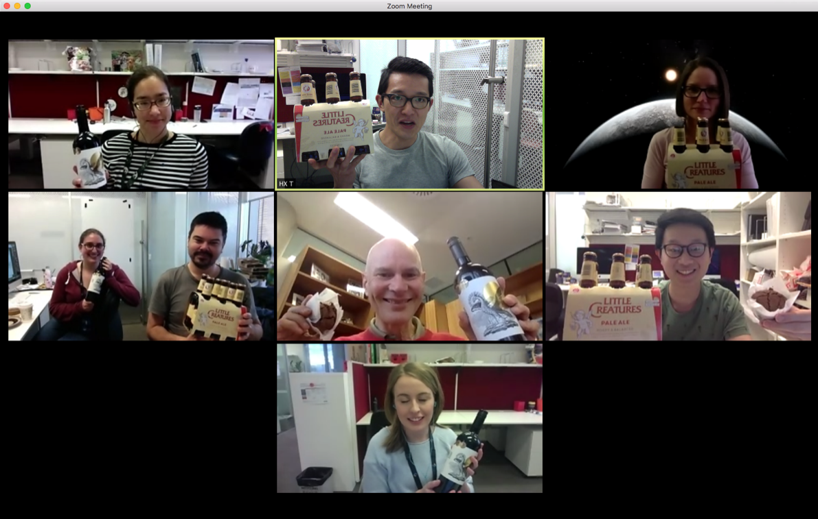 Screengrab of various members of the Kent lab on Zoom, holding celebratory drinks.