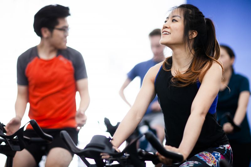 A group of students on exercise bikes in a gym