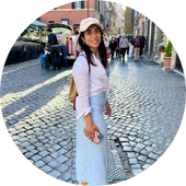 Woman smiling outside on cobble street