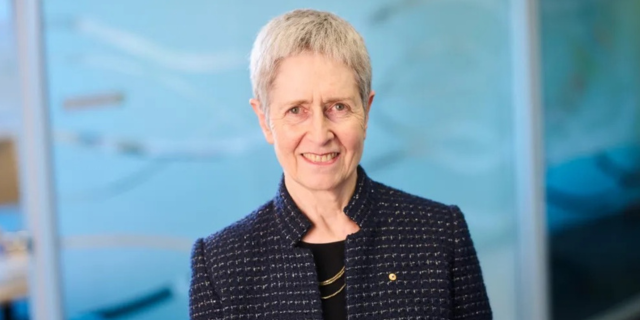 Woman looks at camera smiling